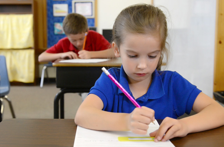 Child using star spacer handwriting tool
